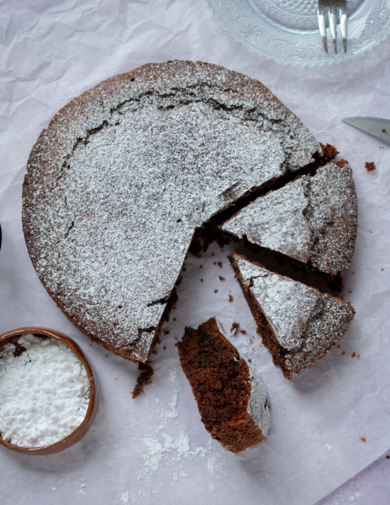 a dairy free chocolate cake with few slices cut