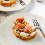 Two toasts with whipped ricotta and figs on a plate