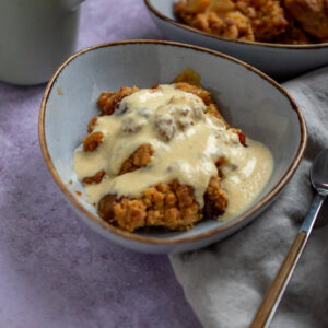 bowls with Apple crumble and warm custard